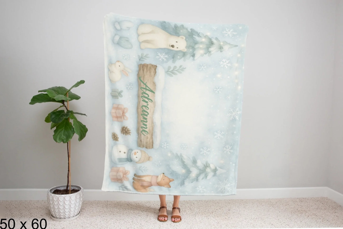 50x60_winter_wonderland_woman_holding_velveteen_blanket_mockup