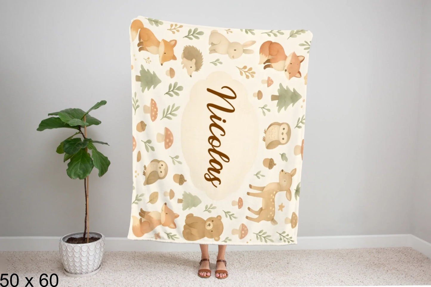 50x60_winter_wonderland_woman_holding_velveteen_blanket_mockup