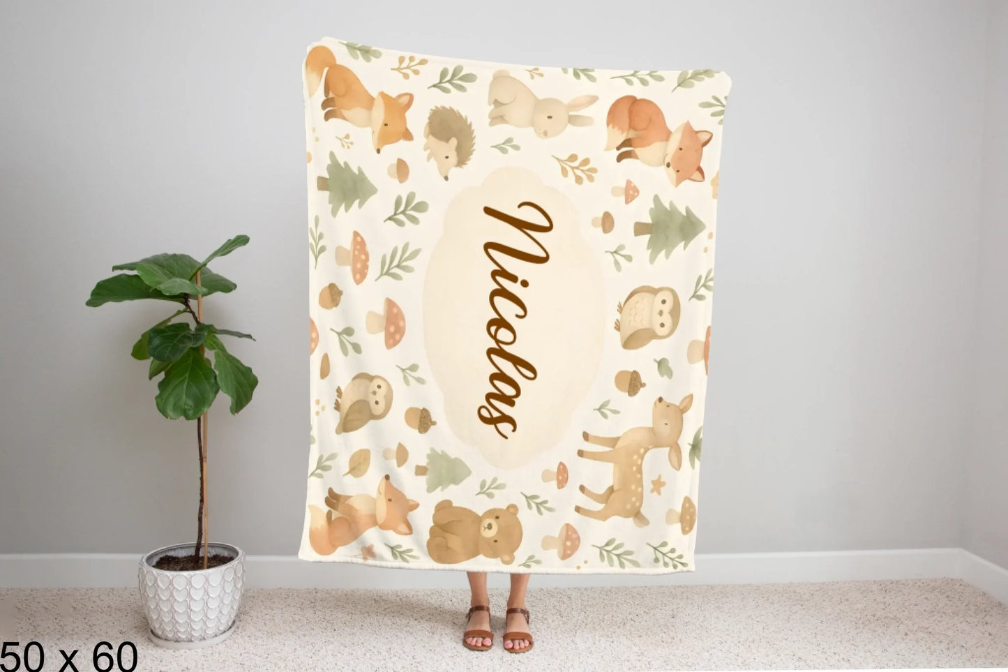 50x60_winter_wonderland_woman_holding_velveteen_blanket_mockup