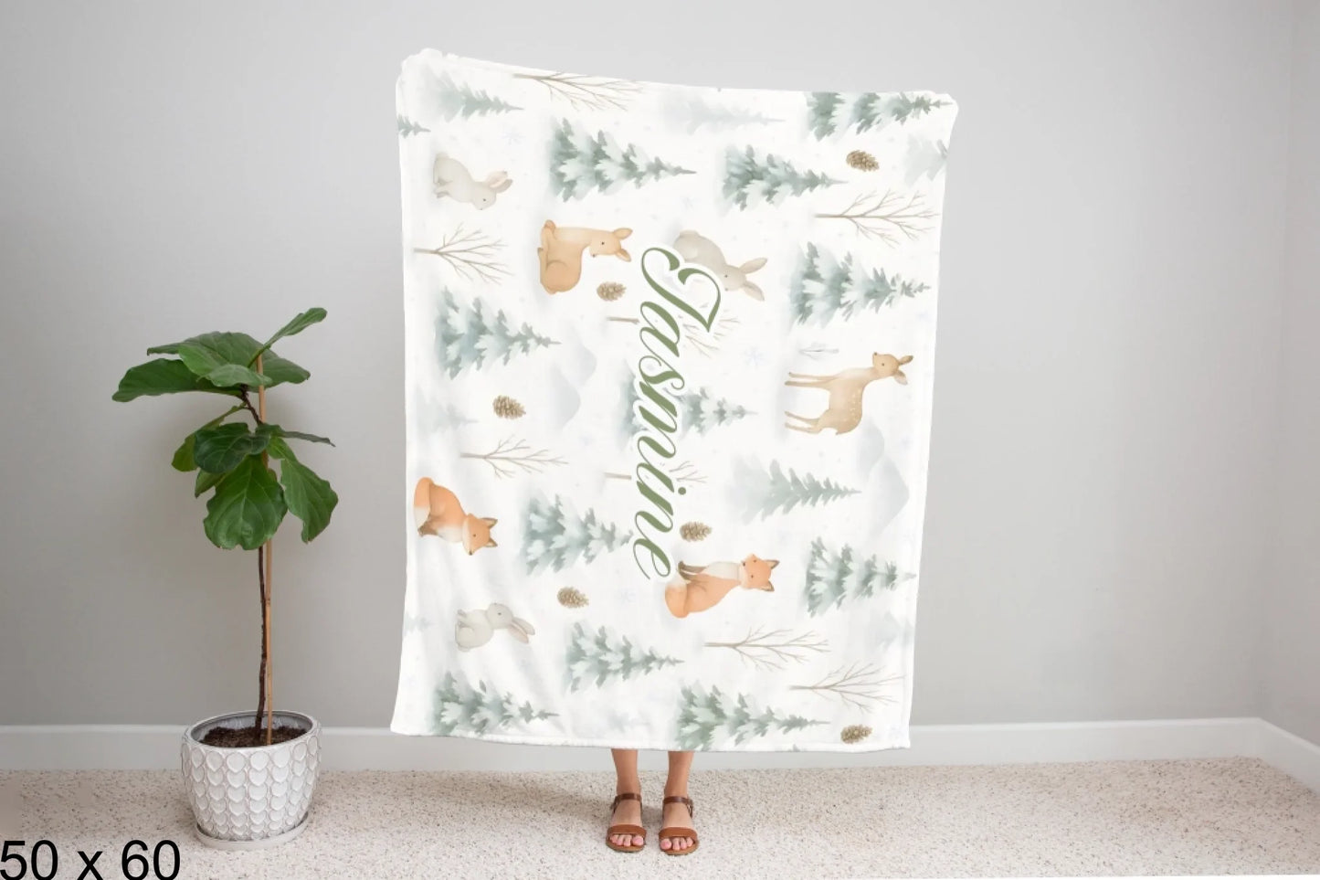 50x60_winter_wonderland_woman_holding_velveteen_blanket_mockup
