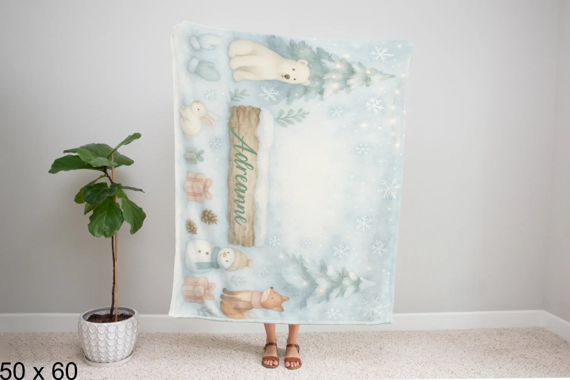 50x60_winter_wonderland_woman_holding_velveteen_blanket_mockup