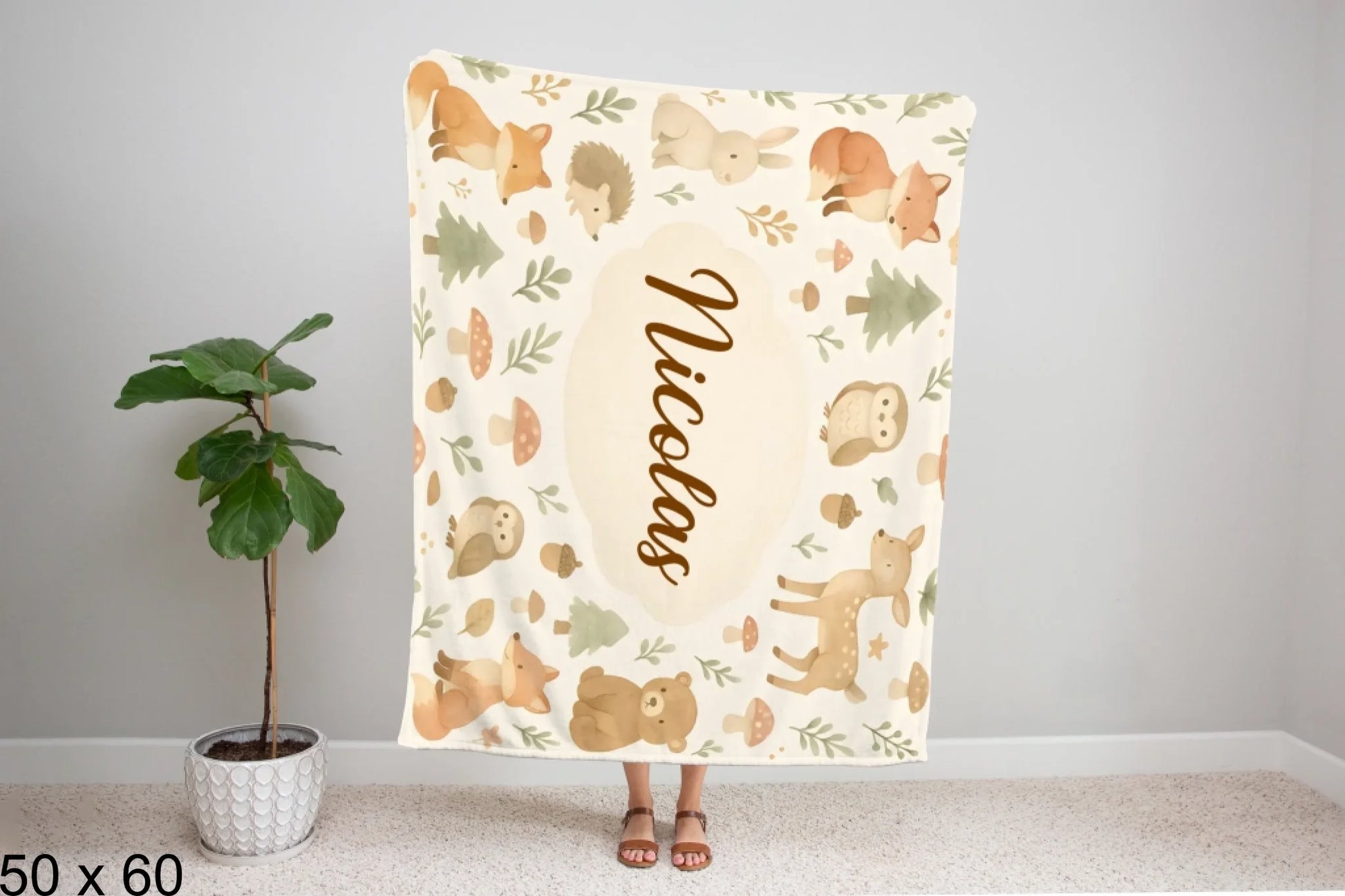 50x60_winter_wonderland_woman_holding_velveteen_blanket_mockup