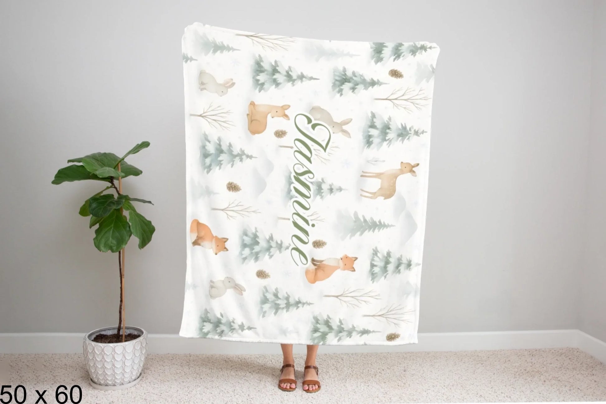 50x60_winter_wonderland_woman_holding_velveteen_blanket_mockup